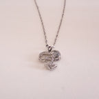Heart-shaped pendant necklace on a light gray background