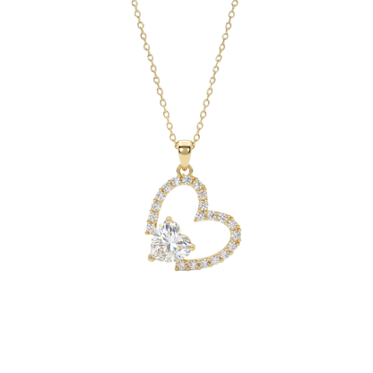 Gold heart-shaped necklace with a clear gemstone on a white background