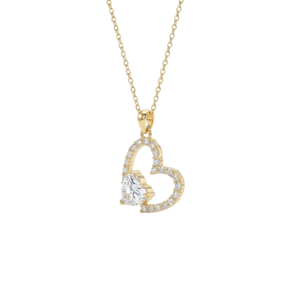 Gold heart-shaped necklace with a clear gemstone on a white background