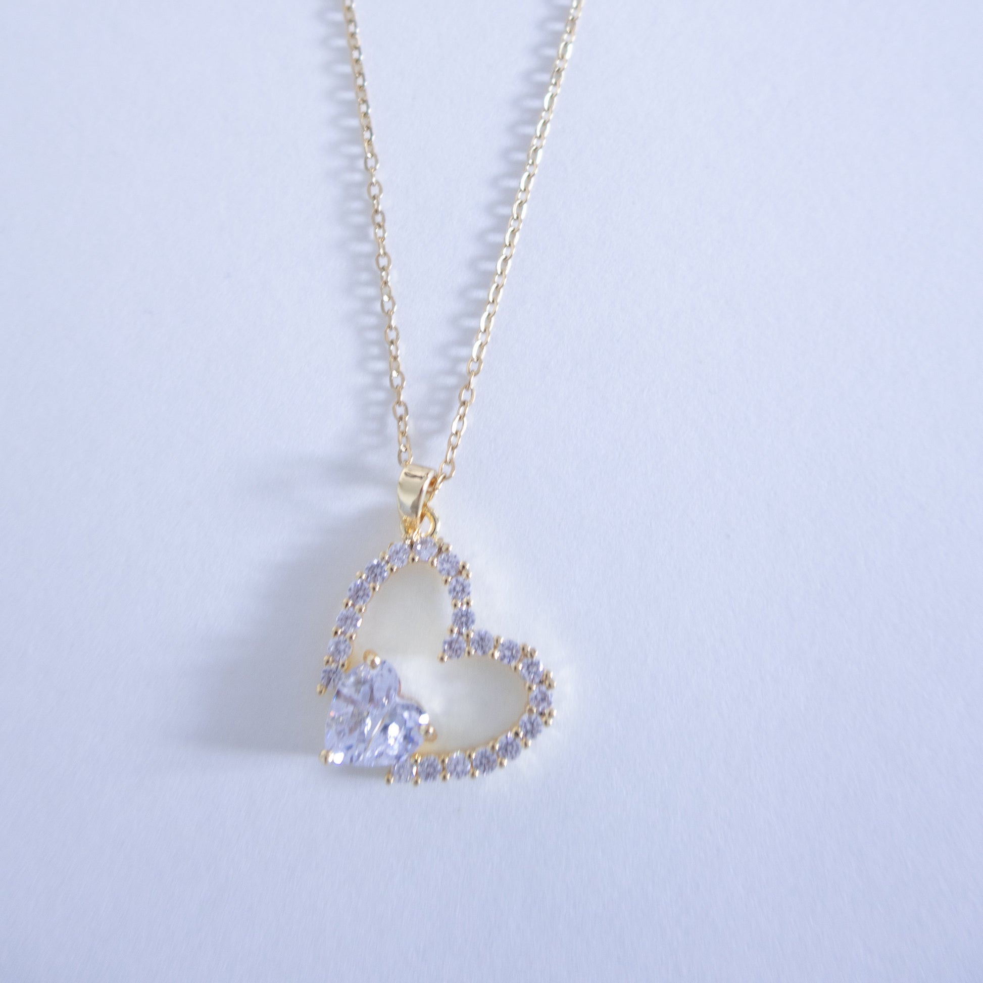 Heart-shaped pendant necklace on a light gray background