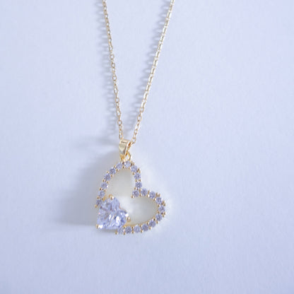 Heart-shaped pendant necklace on a light gray background