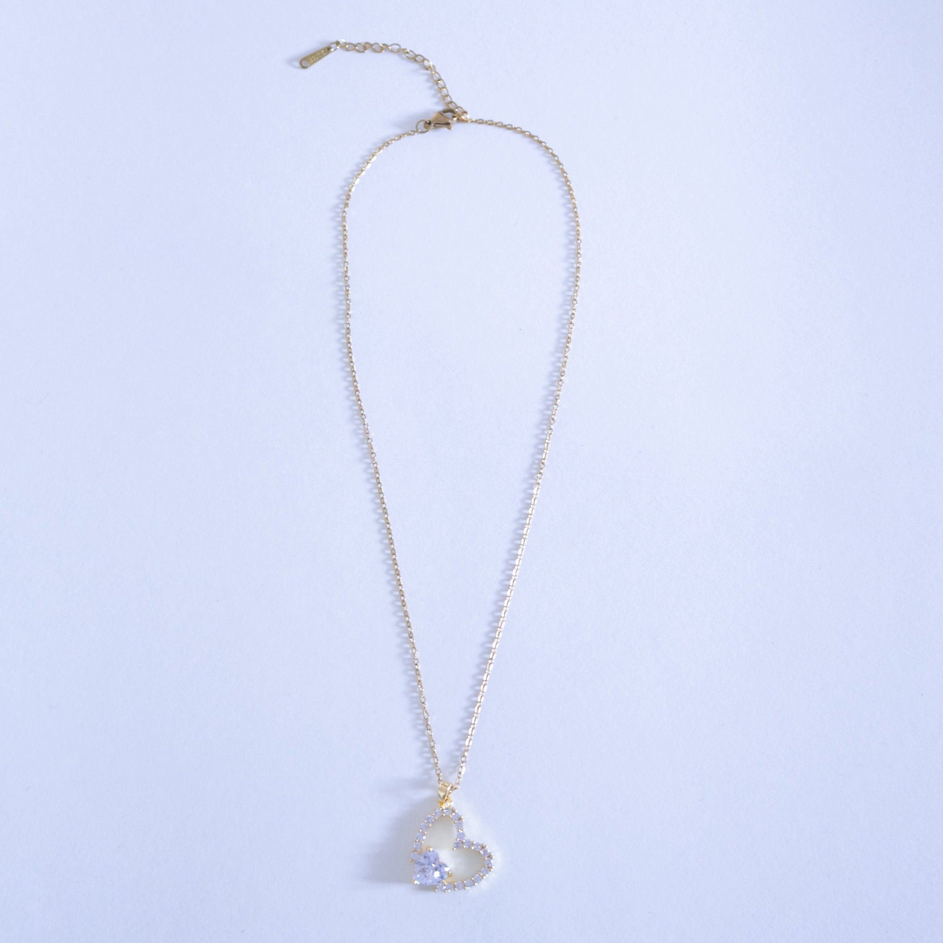 Necklace with a heart-shaped pendant on a light blue background