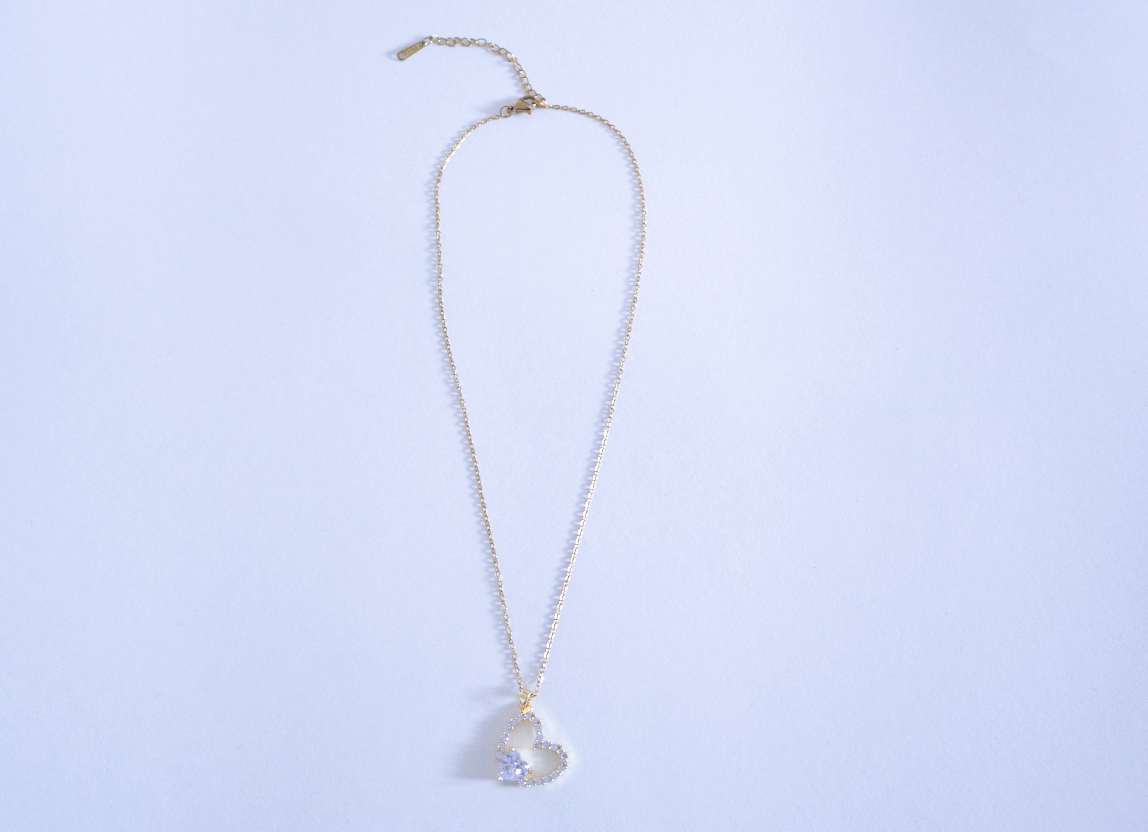 Necklace with a heart-shaped pendant on a light blue background