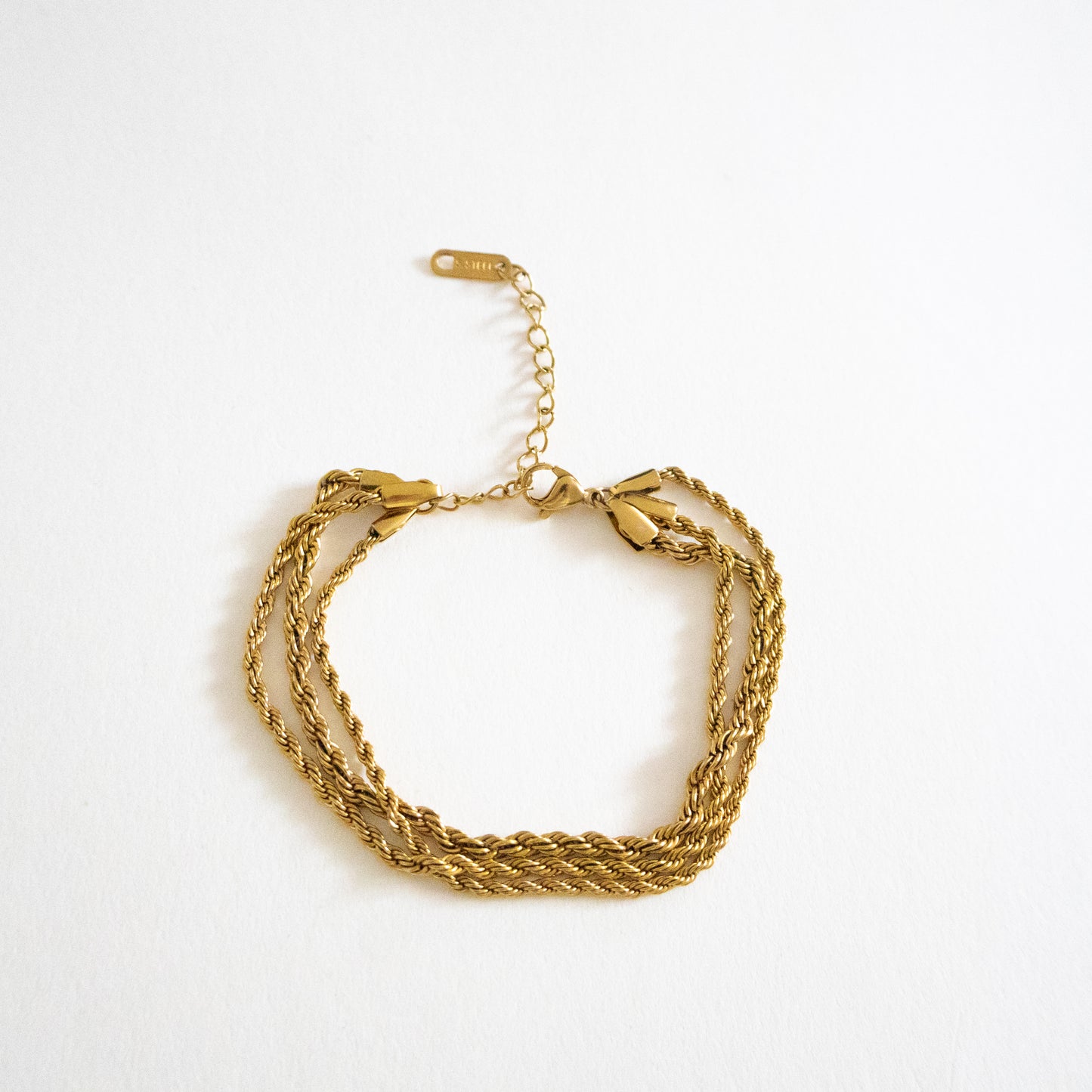 Gold bracelet on a white background