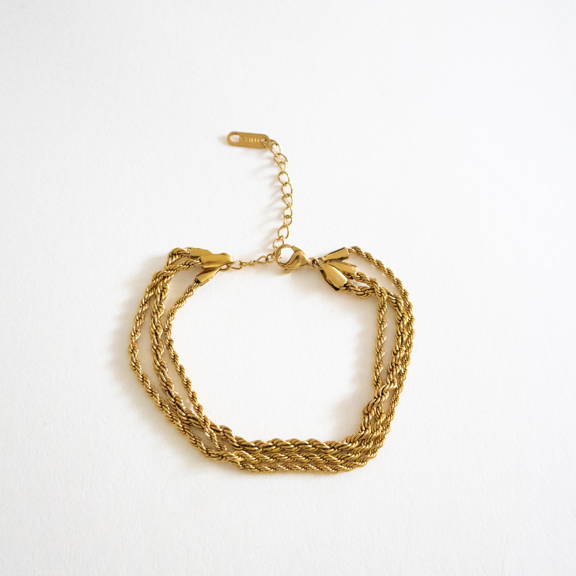 Gold bracelet on a white background