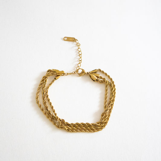 Gold bracelet on a white background
