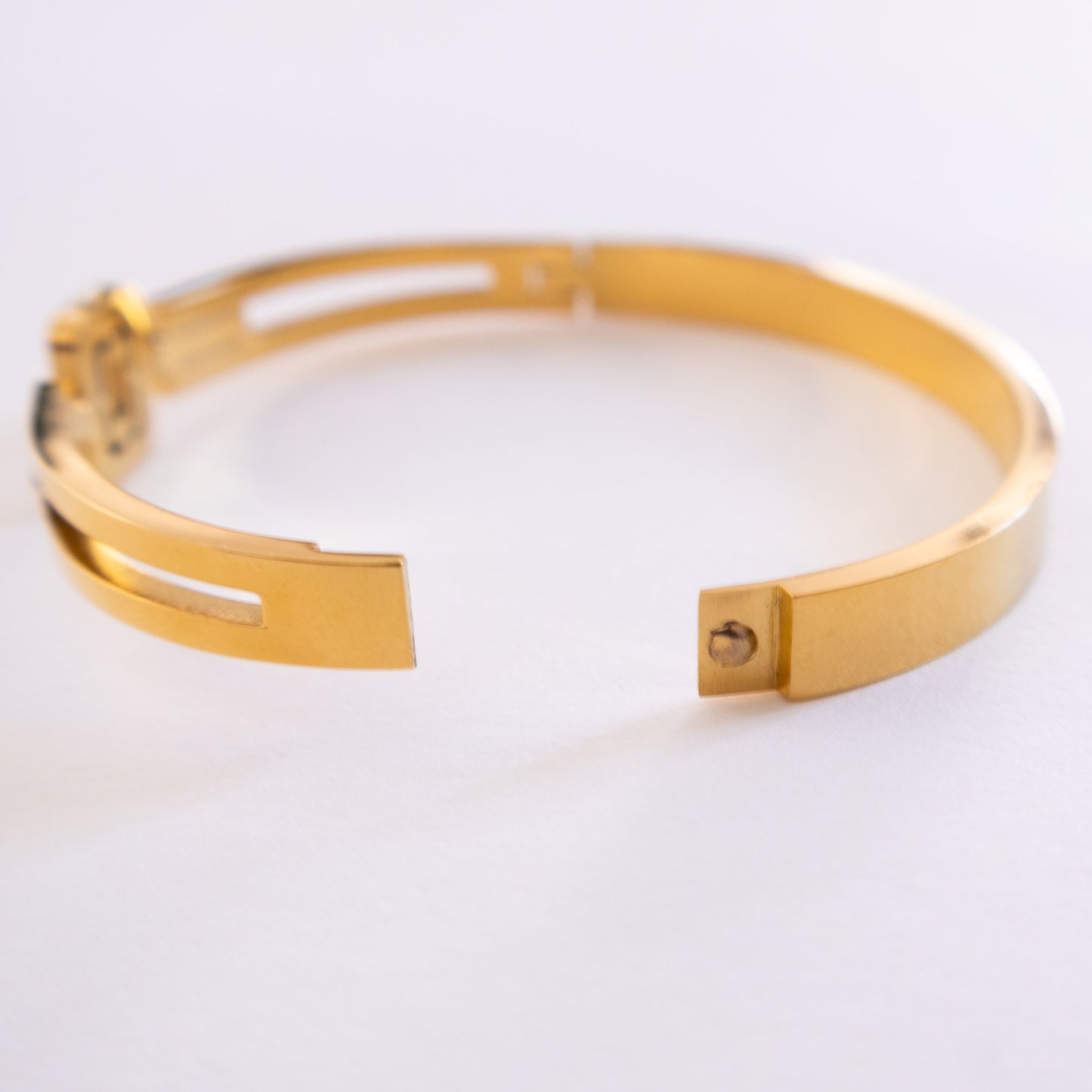 Gold bracelet on a white background