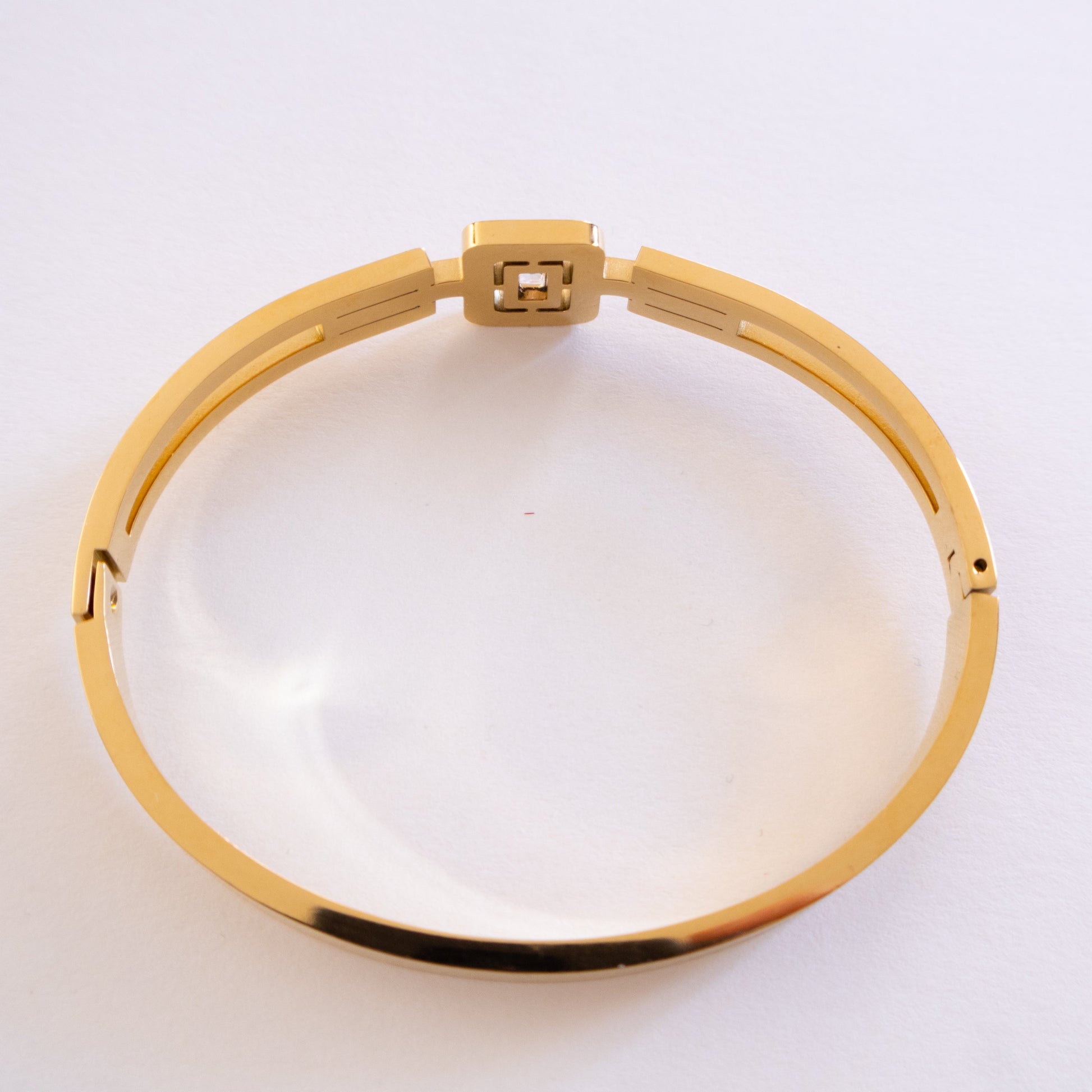 Gold bracelet on a white background