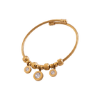 Gold bracelet with circular charms on a white background