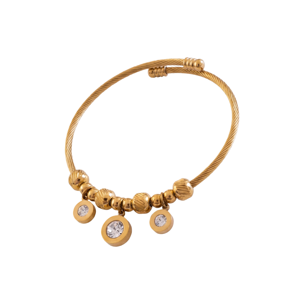 Gold bracelet with circular charms on a white background