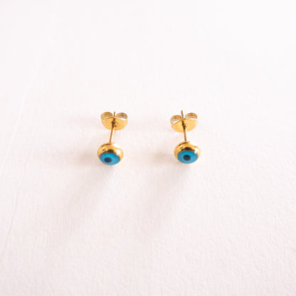 Gold earrings with blue stones on a white background