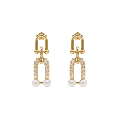 Gold earrings with pearl and diamond-like stones on a white background