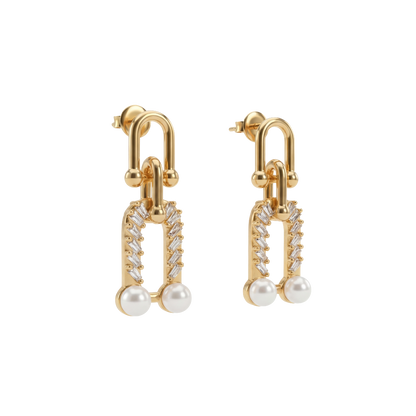Gold earrings with pearl drops on a white background