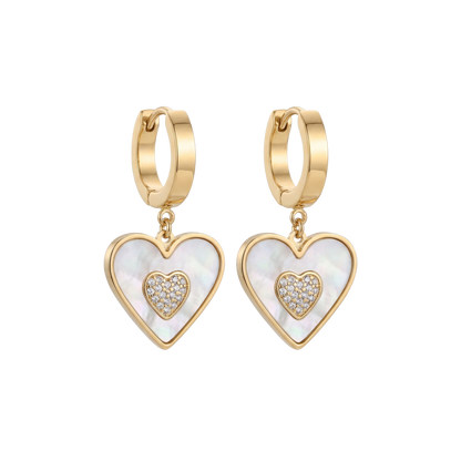Gold heart-shaped earrings with white center and clear stones on a white background