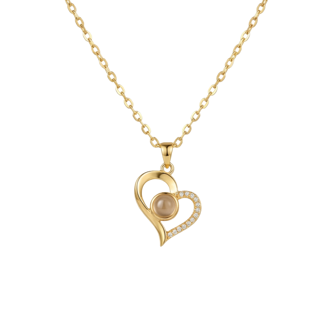 Gold heart-shaped necklace with a pearl center on a white background