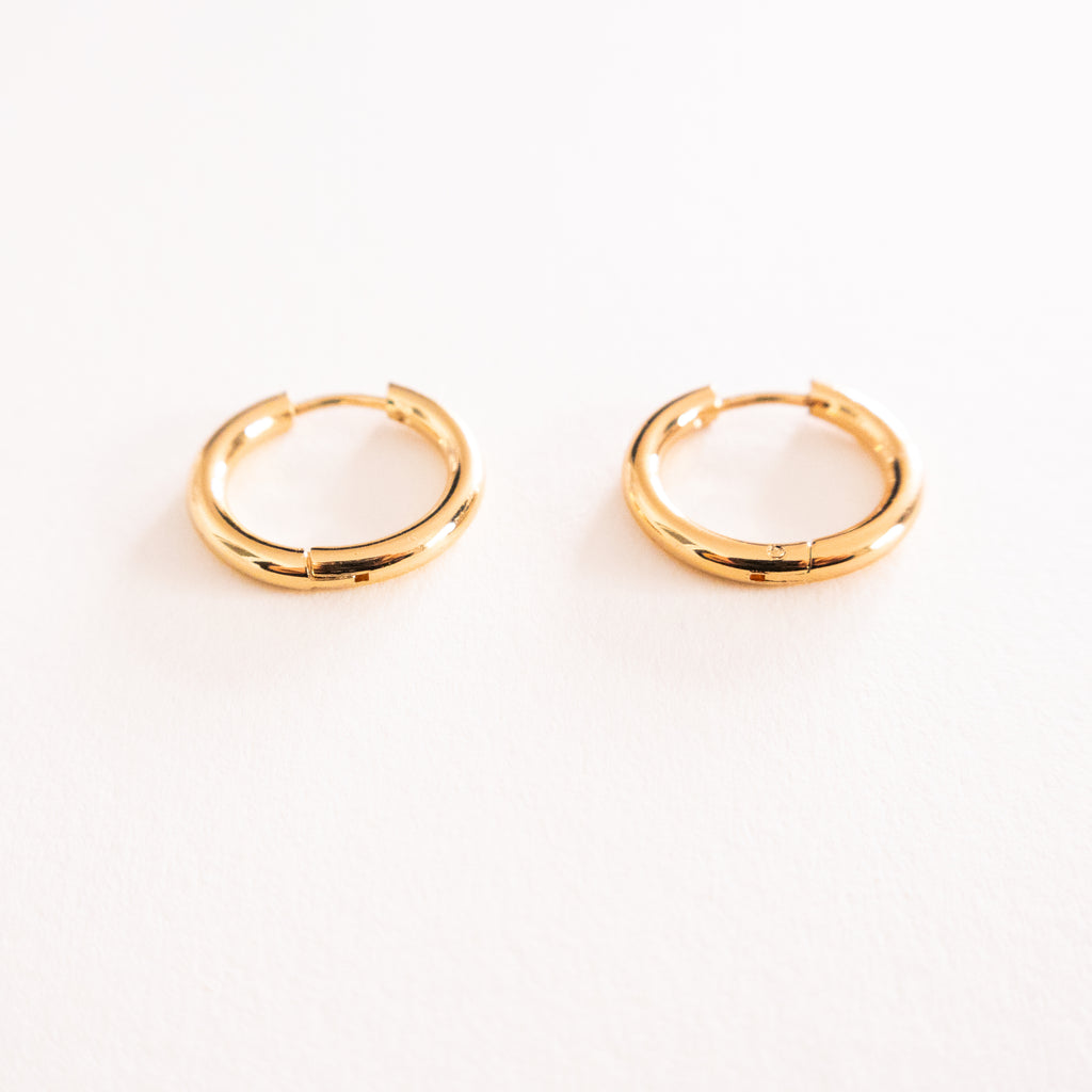 Gold hoop earrings on a white background