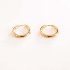 Gold hoop earrings on a white background