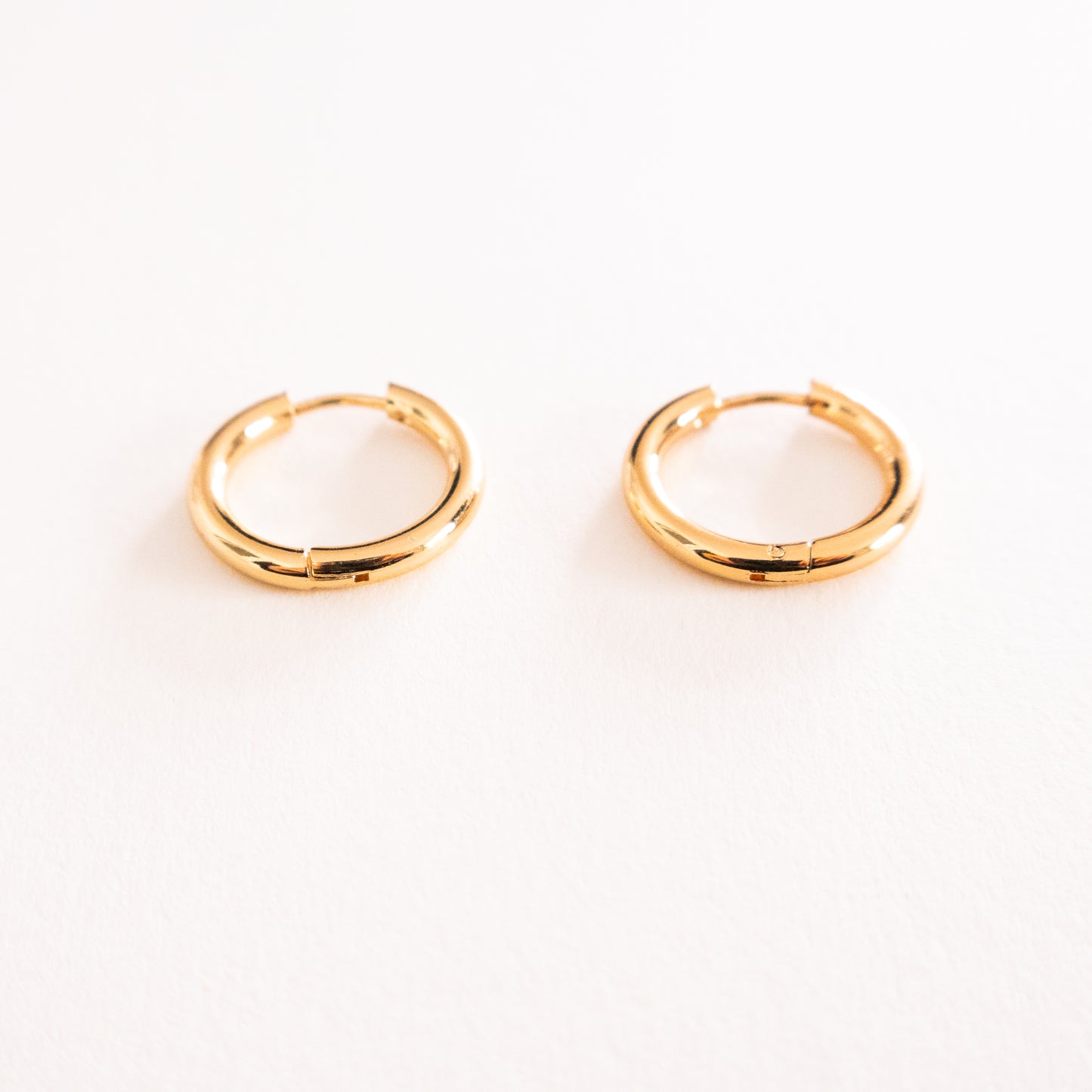 Gold hoop earrings on a white background