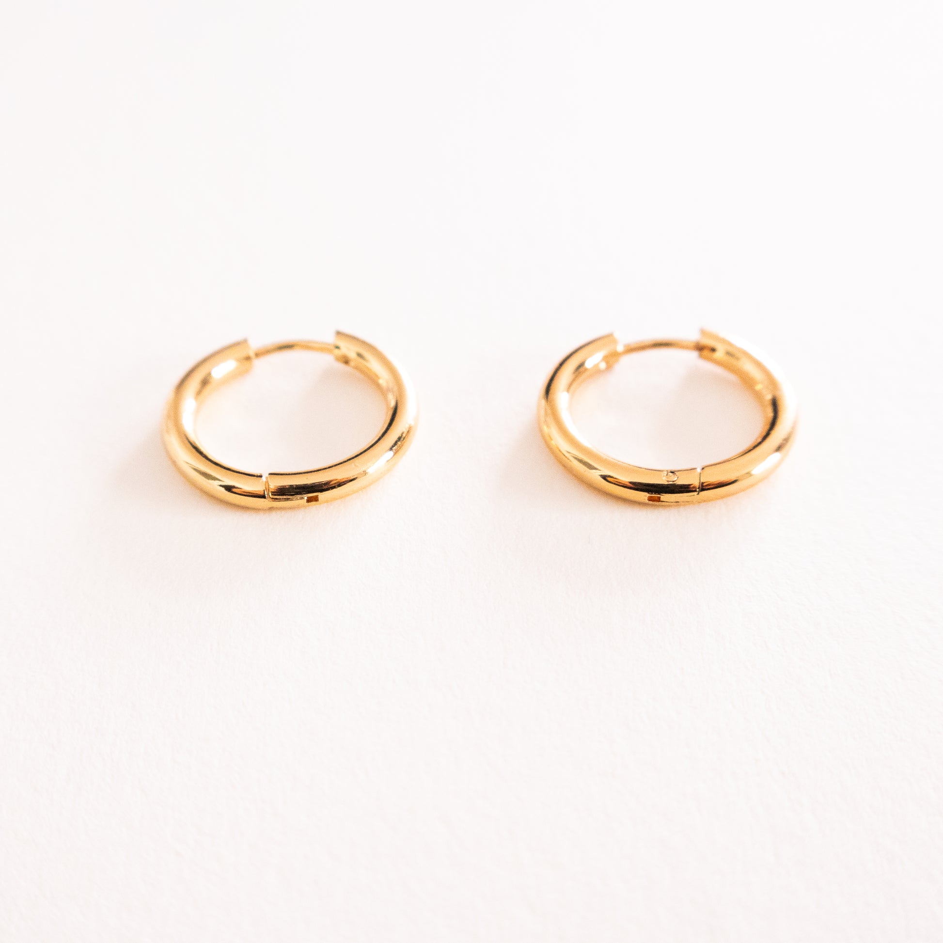 Gold hoop earrings on a white background