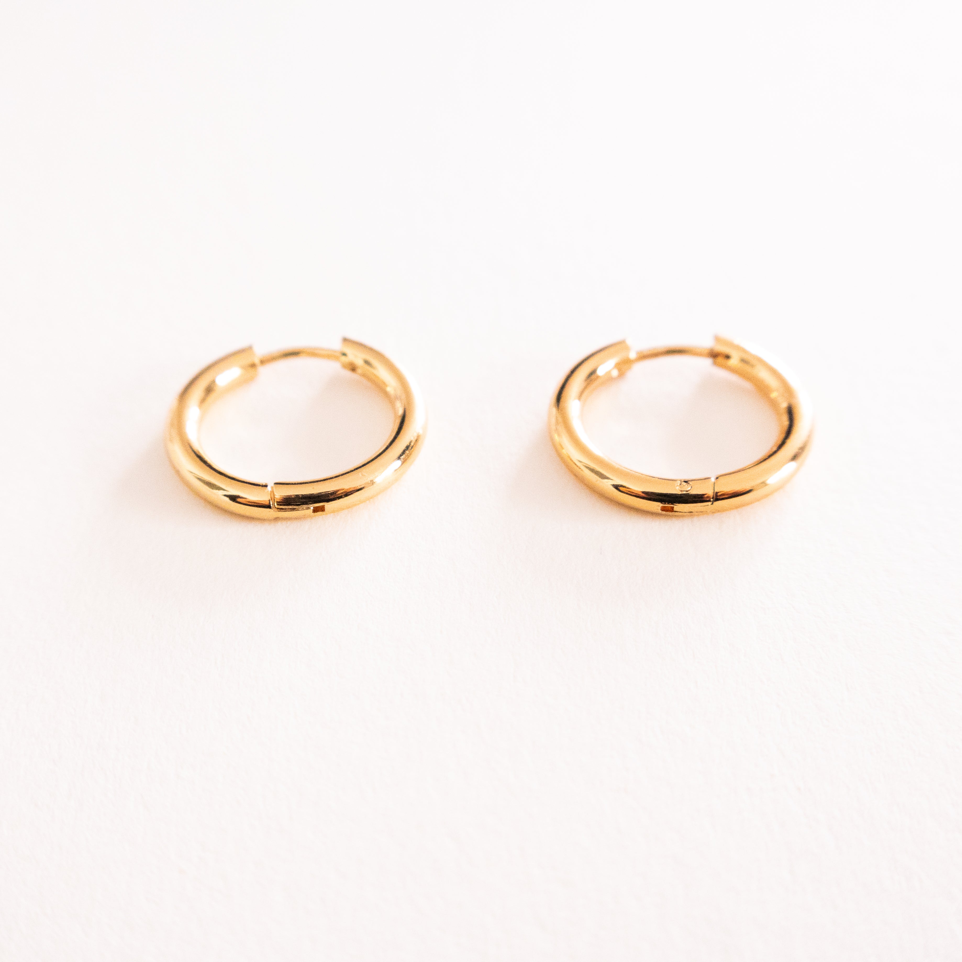 Gold hoop earrings on a white background