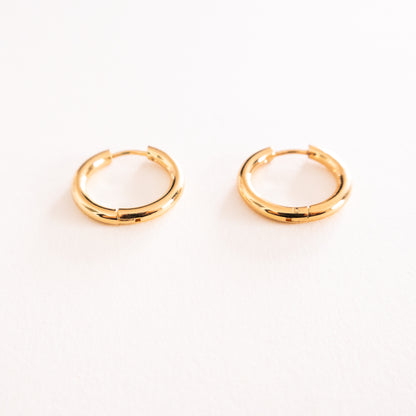 Gold hoop earrings on a white background