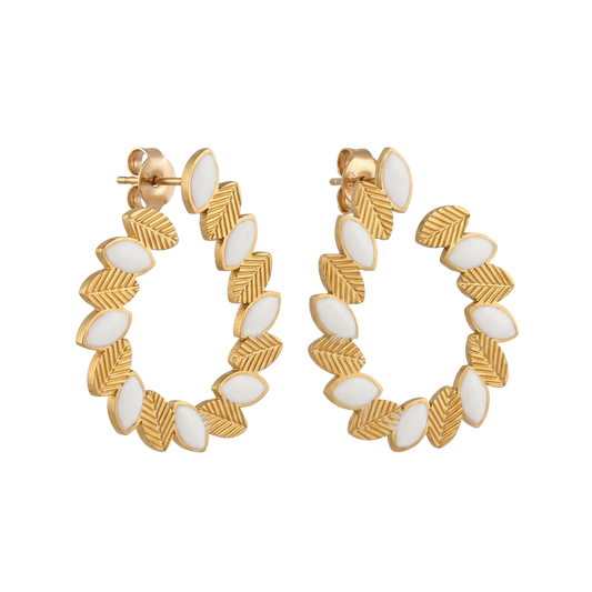 Gold hoop earrings with white accents on a white background