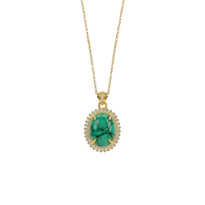Gold necklace with a green pendant on a white background