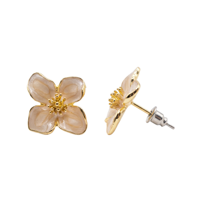 Flower-shaped earrings with gold accents on a white background