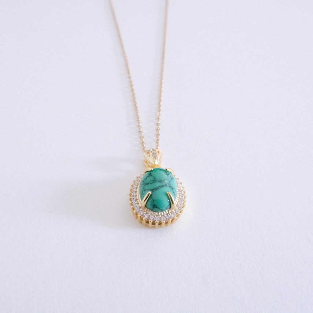 Necklace with a turquoise pendant on a white background