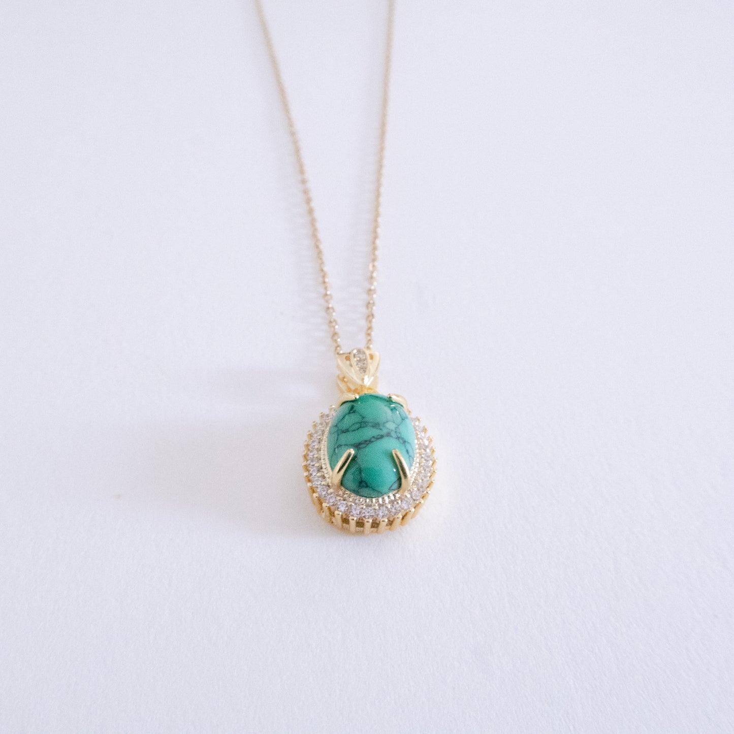 Necklace with a turquoise pendant on a white background