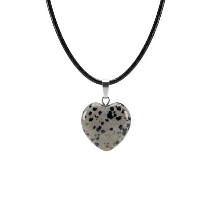 Heart-shaped dalmatian Jasper pendant on a black cord against a white background