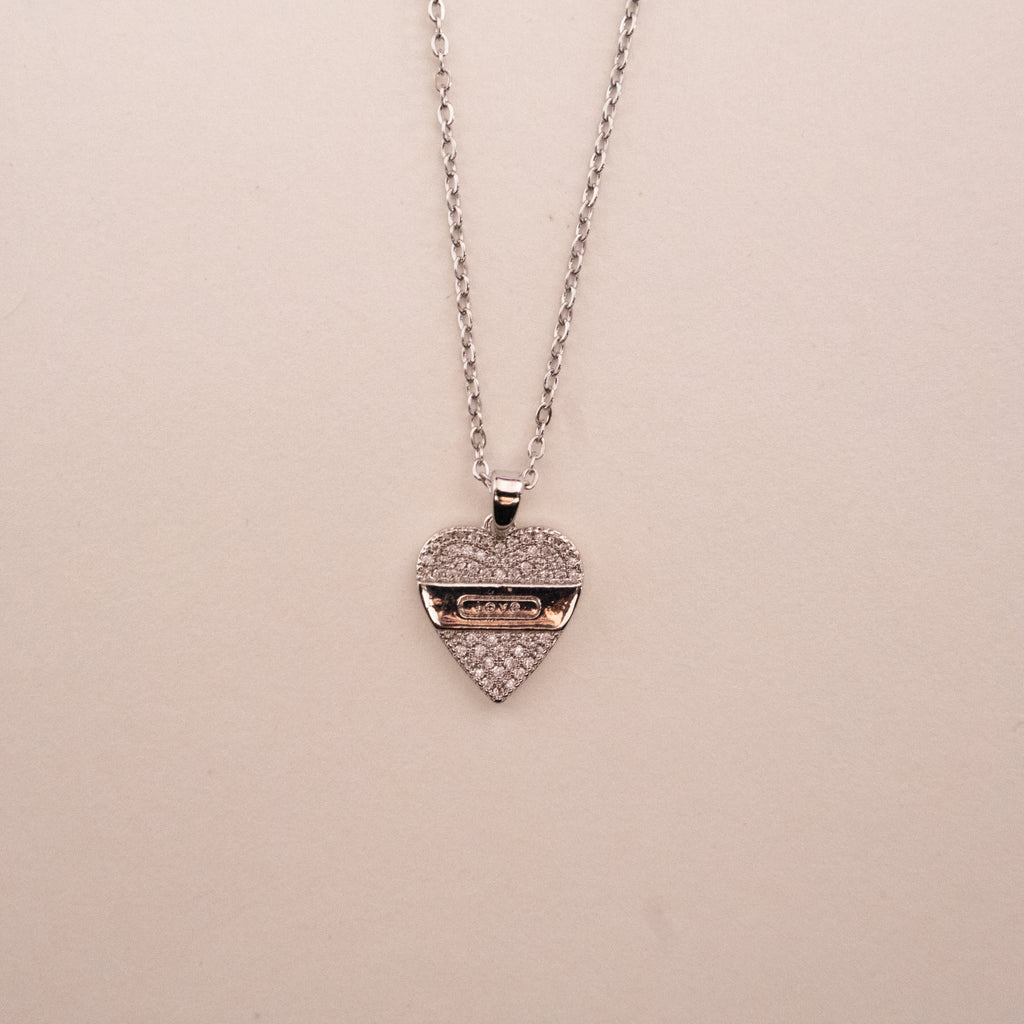 Gold necklace with a green gemstone pendant on a white background