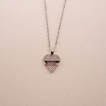 Gold necklace with a green gemstone pendant on a white background