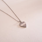 Gold necklace with a green gemstone pendant on a white background