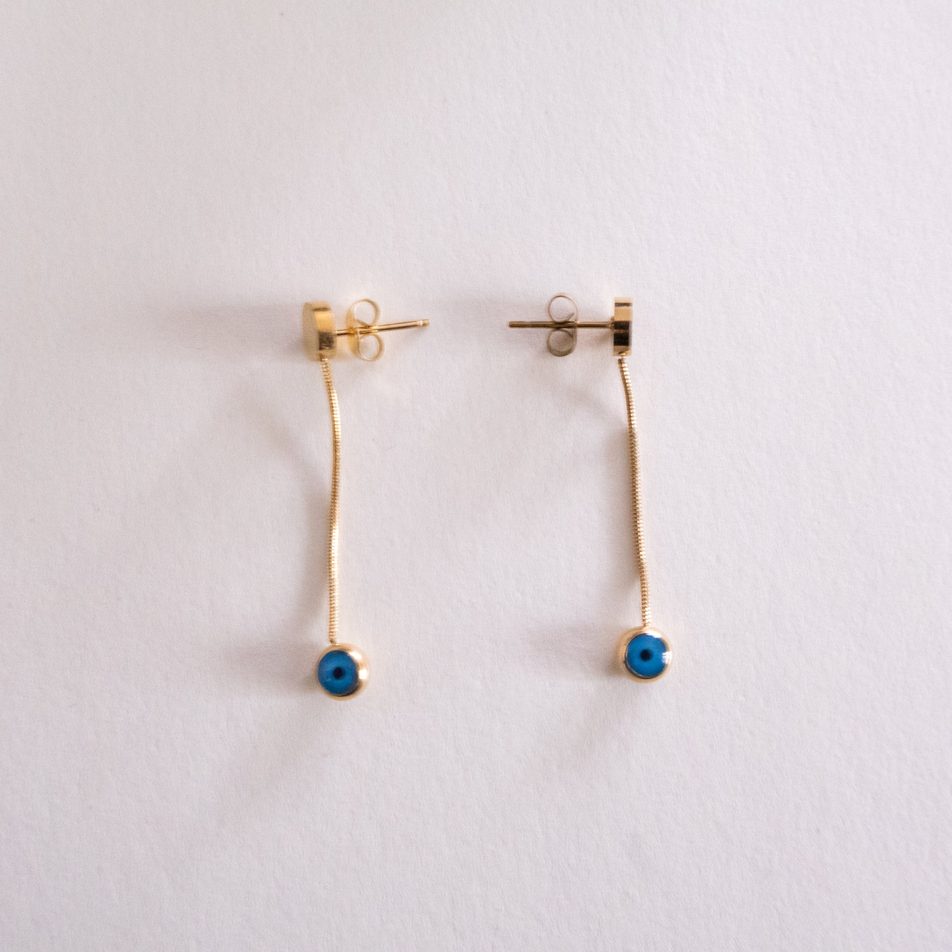 Metallic keychain with spherical ends on a white background