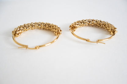 Pair of gold hoop earrings on a white background