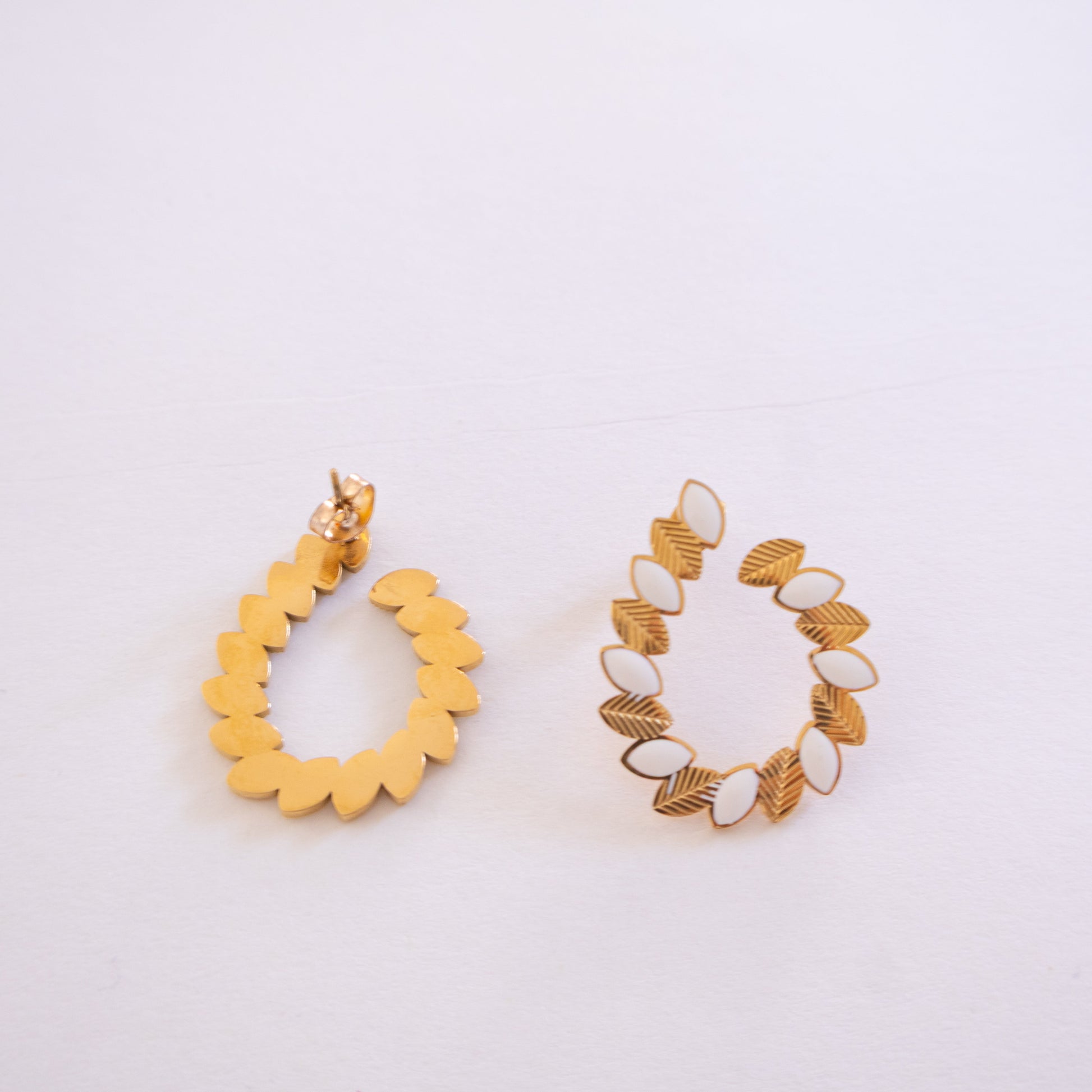 Pair of gold hoop earrings on a light gray background