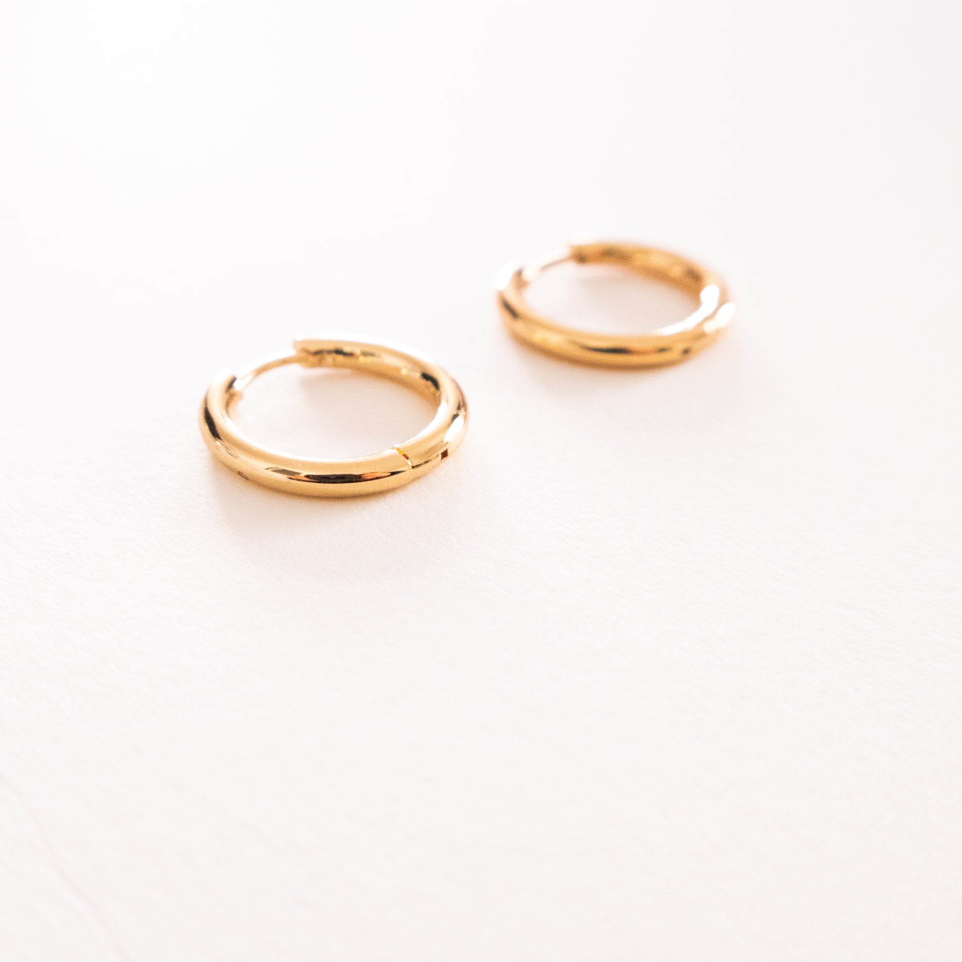 Pair of gold hoop earrings on a white background