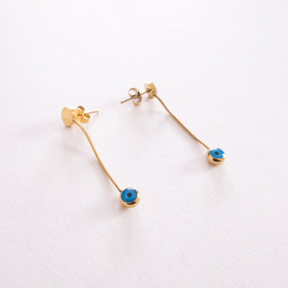 Pair of silver hoop earrings with blue and white circular designs on a white background