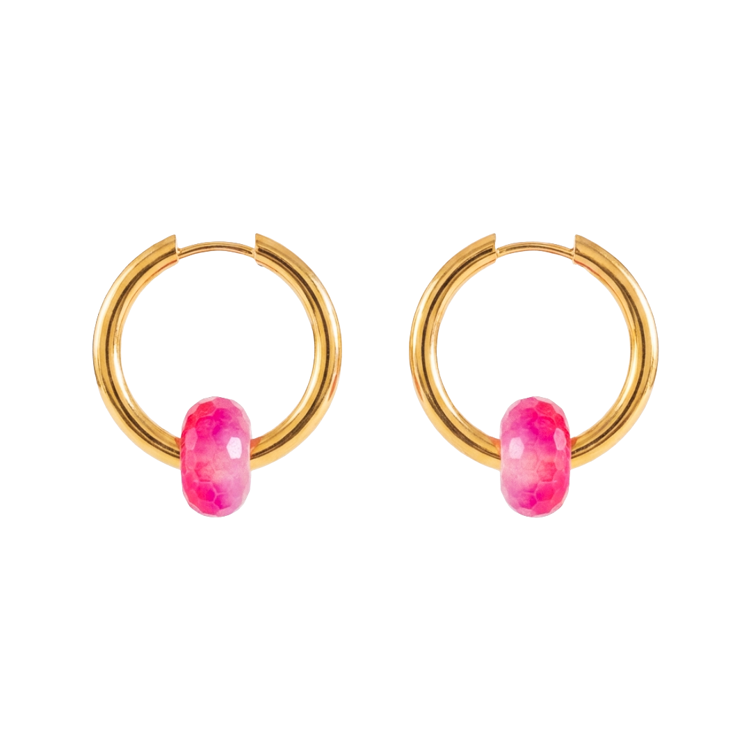Gold hoop earrings with pink gemstones on a white background