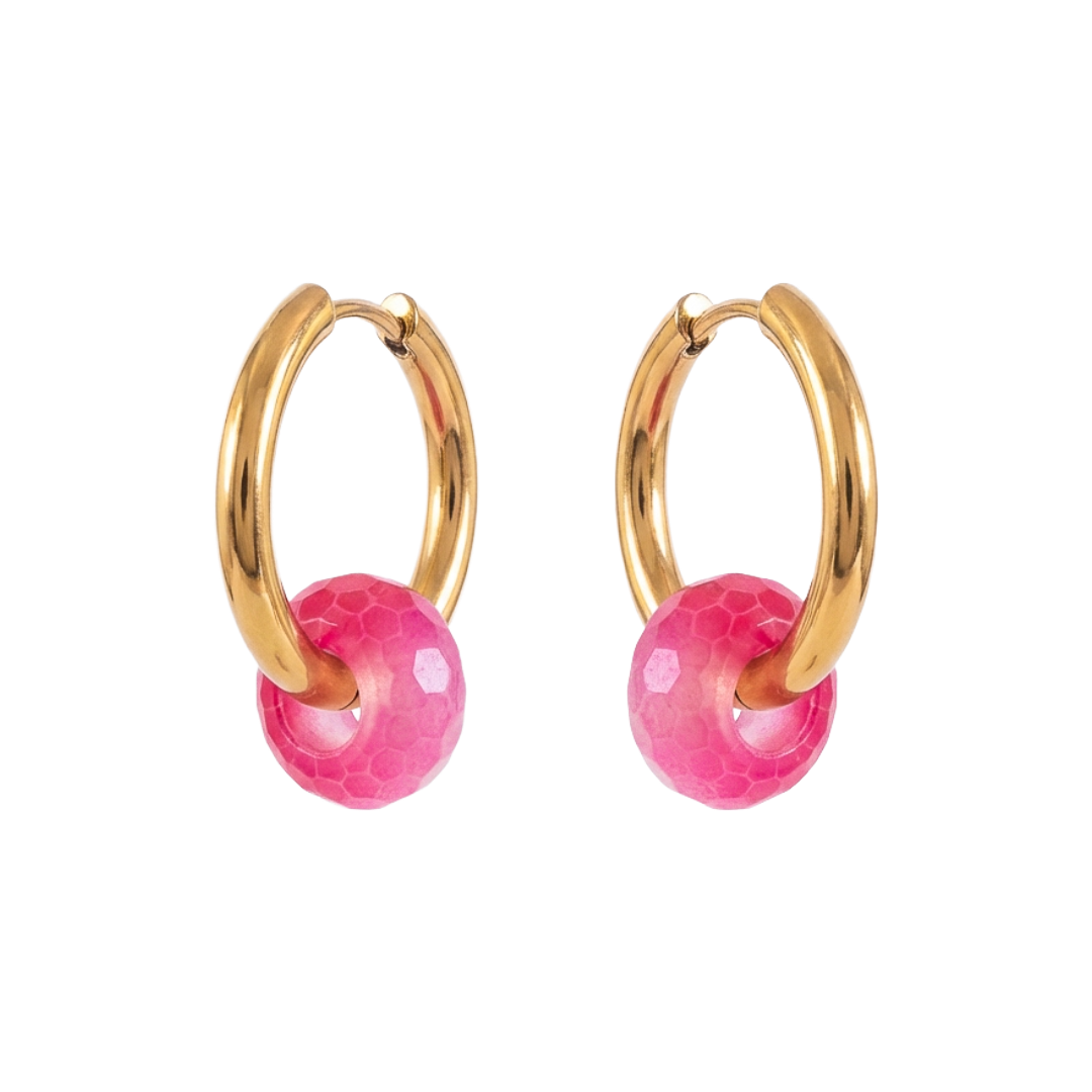 Gold hoop earrings with pink spherical charms on a white background