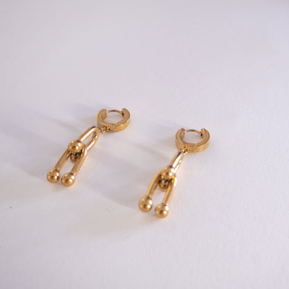 Pair of gold hoop earrings on a white background