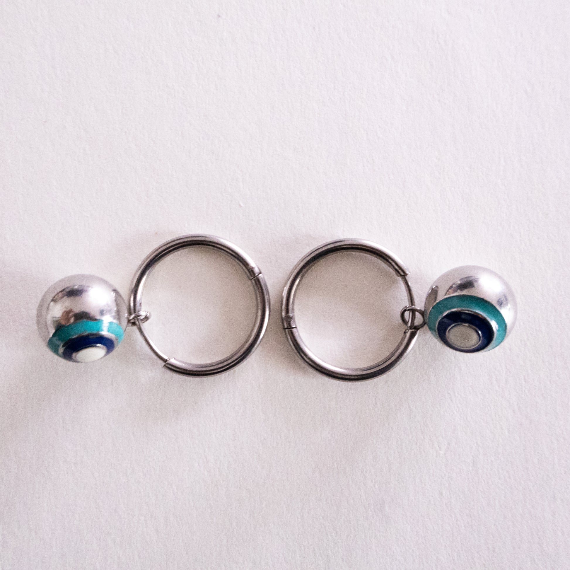 Green stone pendant on a black cord against a white background