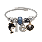 Silver bracelet with various charms including a dolphin, pearl, and shell on a white background