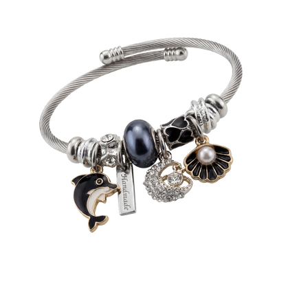 Silver bracelet with various charms on a white background