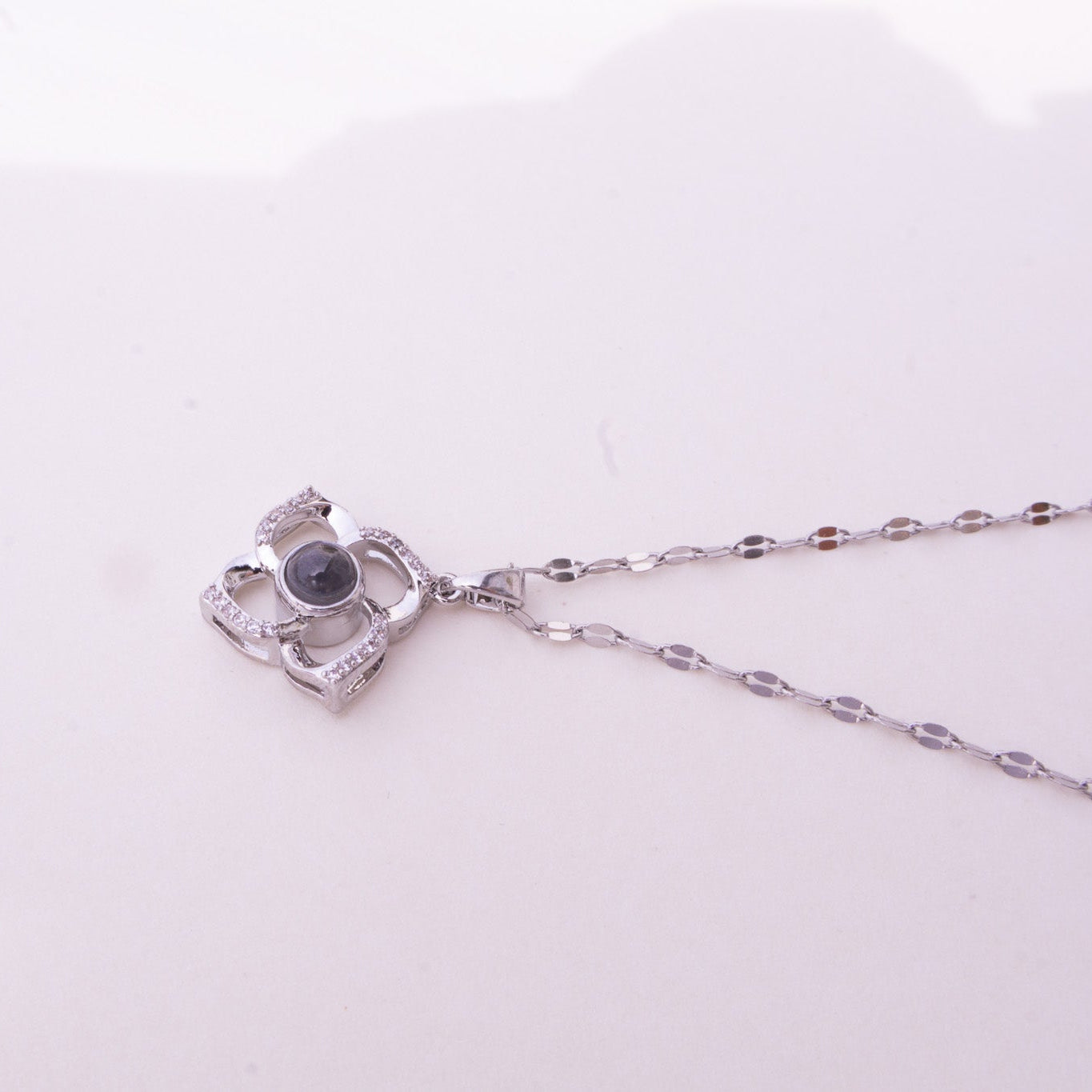 Silver necklace with a pendant on a white background