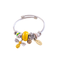 Bracelet with bee charm and other beads on a white background