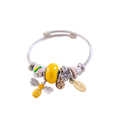 Bracelet with bee charm and other beads on a white background