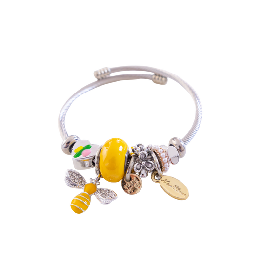 Bracelet with bee charm and other beads on a white background