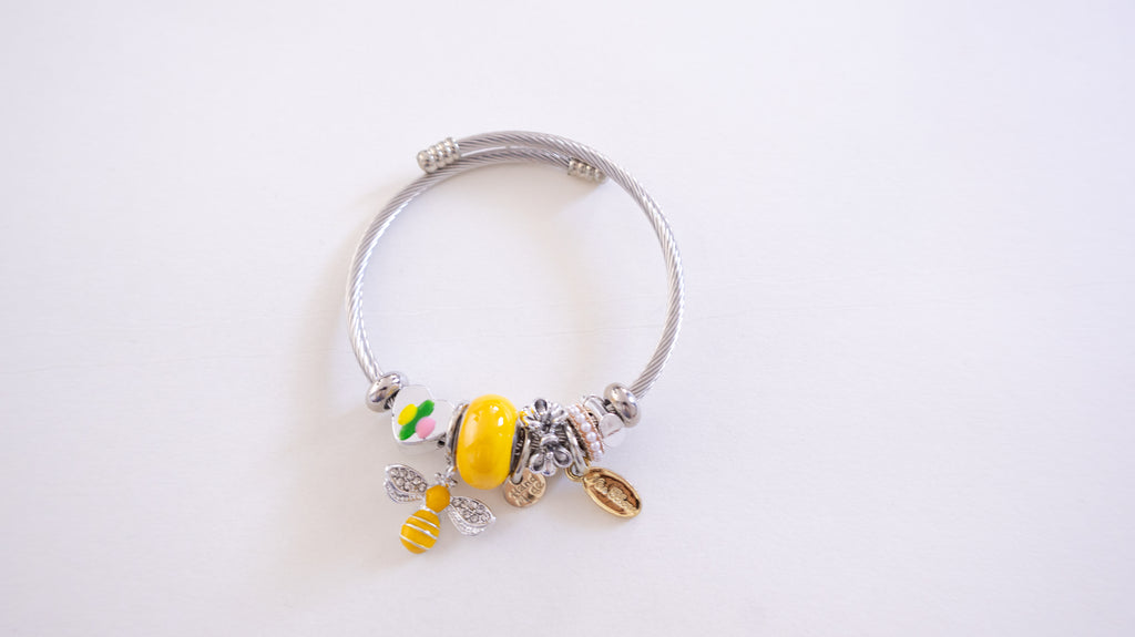 Silver bracelet with colorful charms on a white background